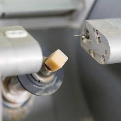 Dental milling machine fabricating a same-day ceramic dental crown.
