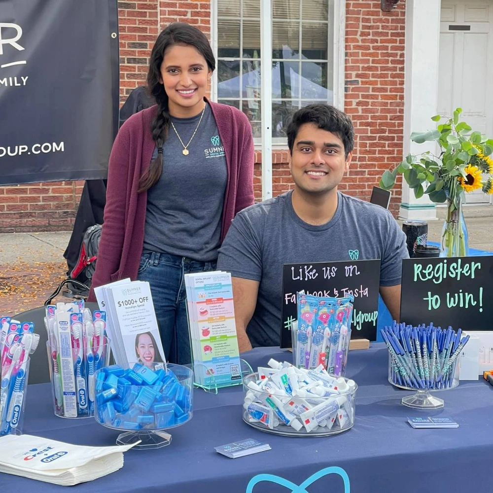 Dr. Dushyant Patel and a team member at a Sumner Dental Group community event.