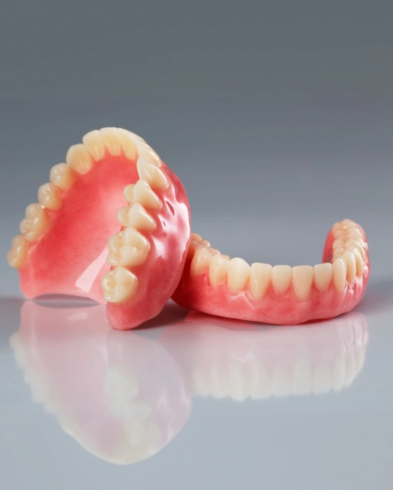 Full dentures replacing missing teeth to restore a complete smile and oral function.