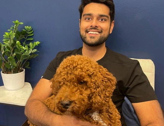 Dr. Patel with Teddy, the office dog