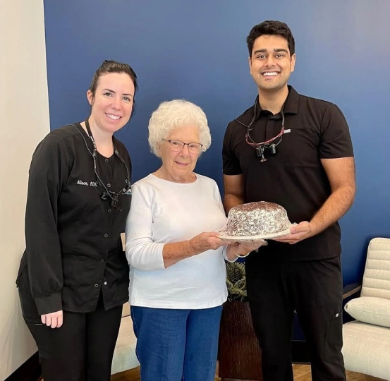 Dentists at Sumner Dental Group celebrating with a patient inside the Gallatin, TN dental office.