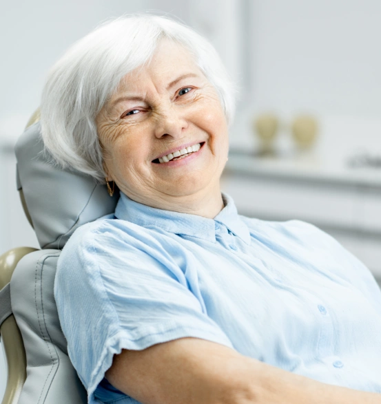 A senior patient smiling comfortably after receiving restorative root canal therapy